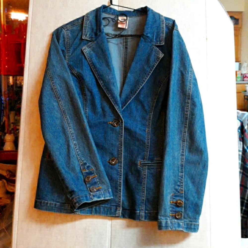 This is a nice Jean jacket with buttons on the sleeves. The back is fitted with.